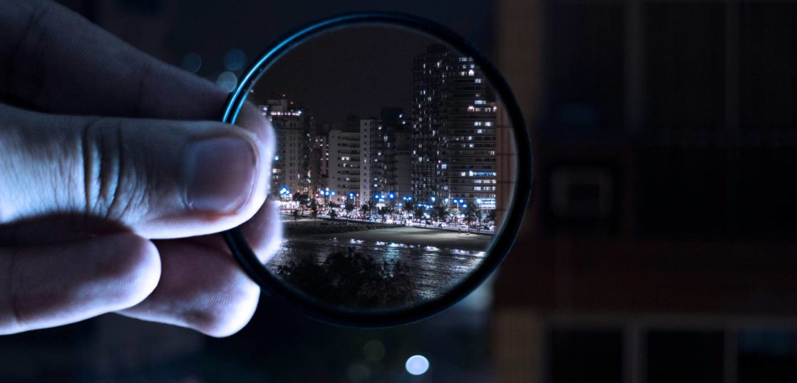 person holding magnifying glass